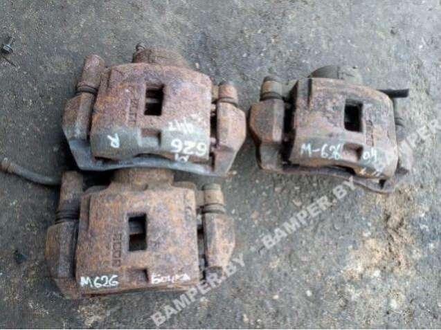 суппорт передний левый Mazda 626 GE 1995 - фото №1